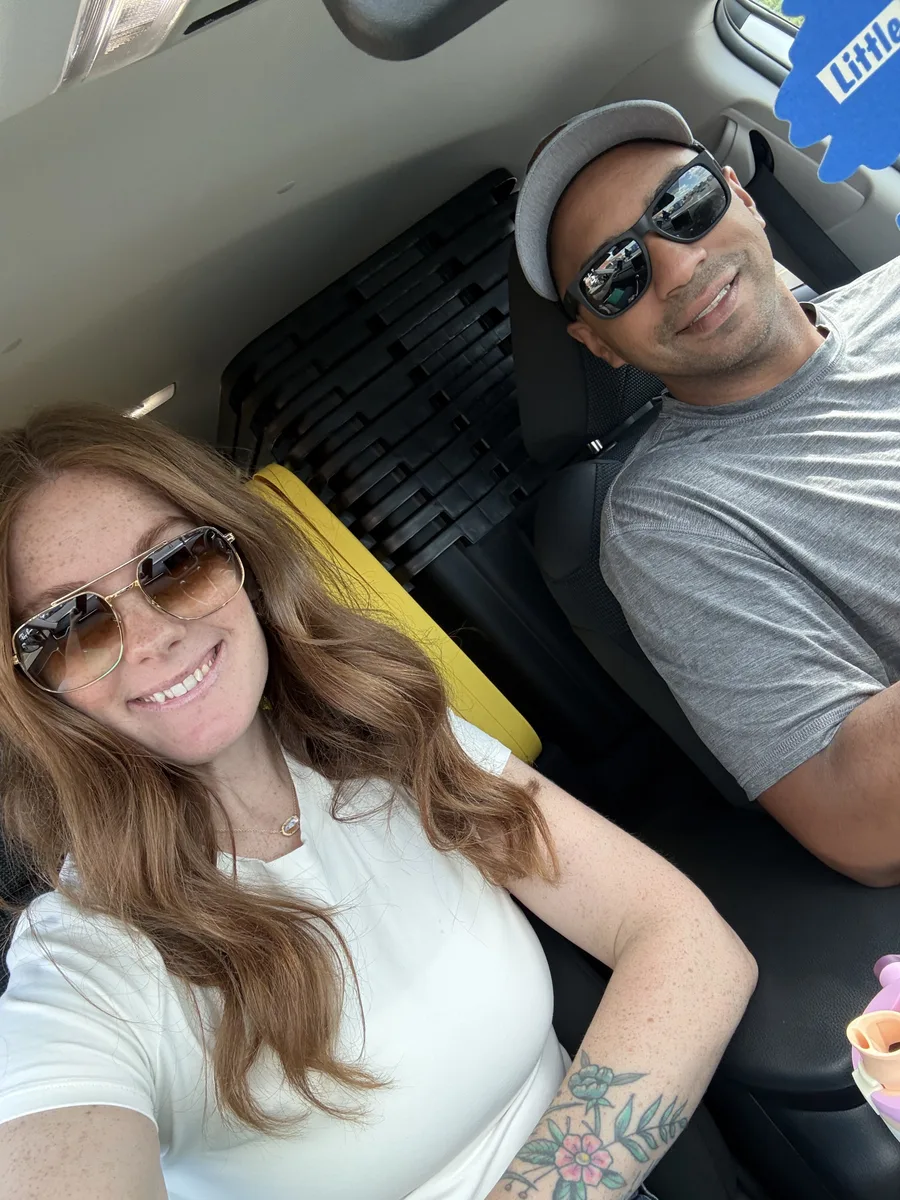 Erica and Tyler smiling together in their delivery vehicle